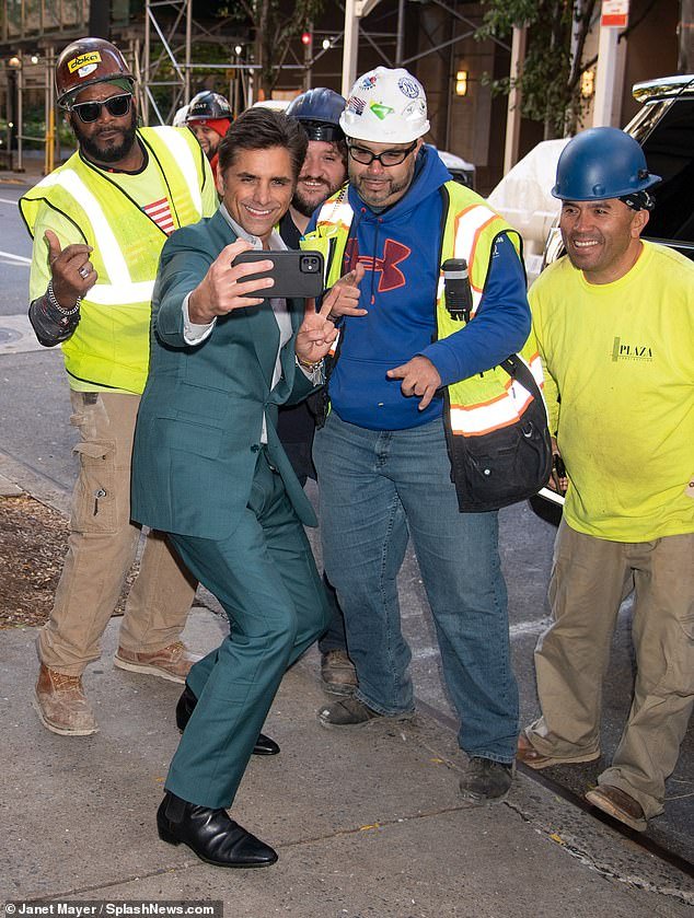 John Stamos Smiles and Gives Peace Sign While Posing for Selfie with Construction Workers in NYC, Promoting his Captivating New Memoir