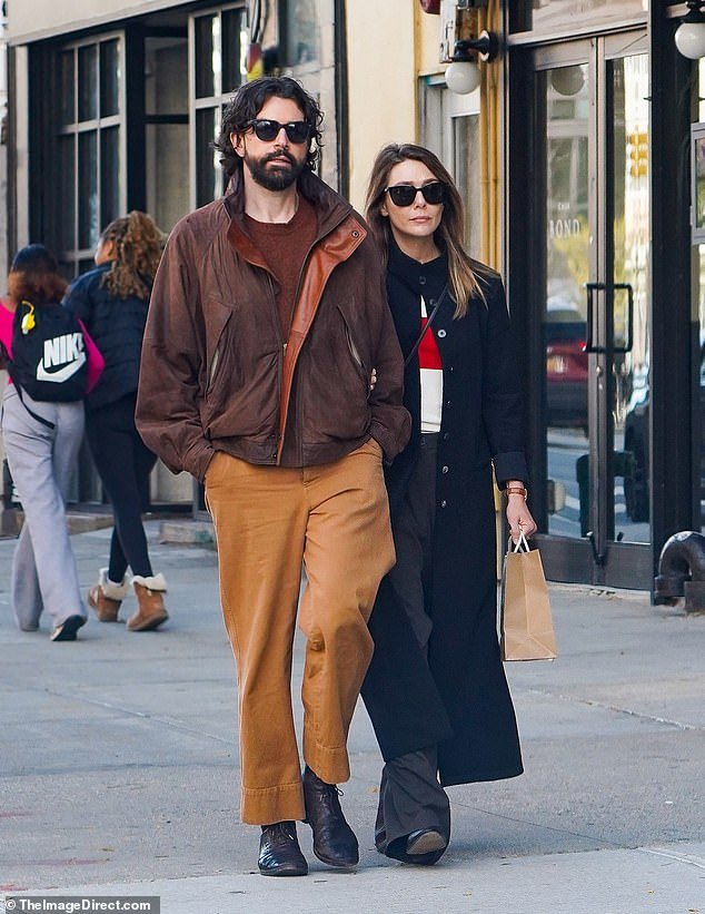 Elizabeth Olsen and husband Robbie Arnett seen arm in arm while shopping for her nephew in NYC, following sister Ashley’s low-key baby boy arrival