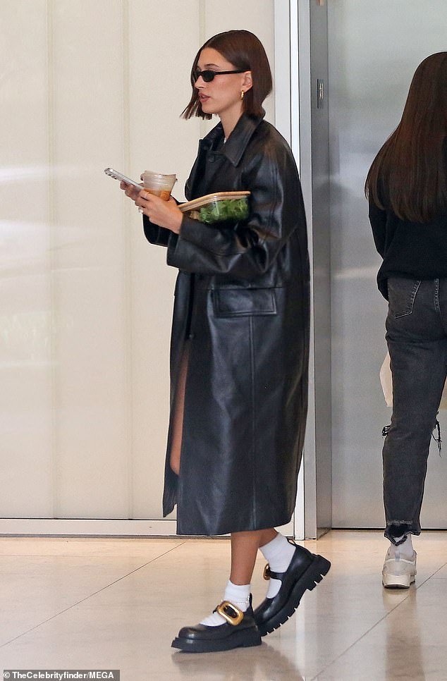 Hailey Bieber embraces The Matrix-inspired style in long black trench coat and chunky boots while out and about in Los Angeles