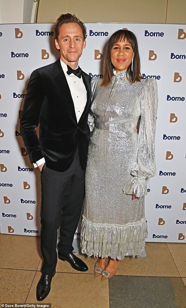 Zawe Ashton stuns in a silver midi dress alongside her stylish fiancé Tom Hiddleston at the Borne to Dance Gala