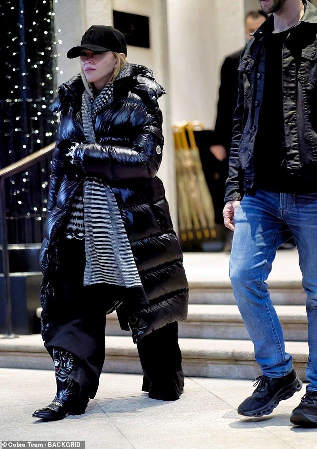 Madonna Spotted in Milan Wearing a Black Padded Coat and Cowboy Boots ...