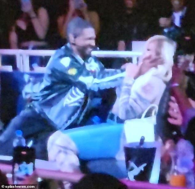 Mary J. Blige and Usher engage in playful wrestling at the end of his Las Vegas residency show