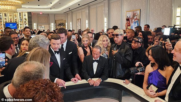 Cher, 77, and her boyfriend Alexander “A.E.” Edwards, 37, make funny faces while watching Justin Timberlake gamble at the grand opening of the new .7bn Fontainebleau hotel in Vegas