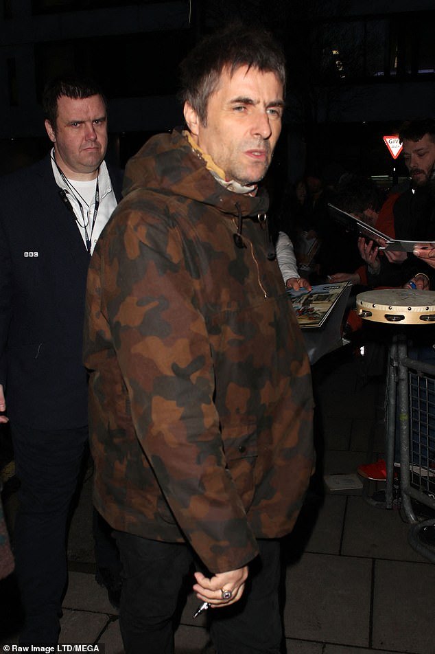 Liam Gallagher and Debbie Gwyther coordinate in cute matching brown coats as they depart BBC Radio 2 studios