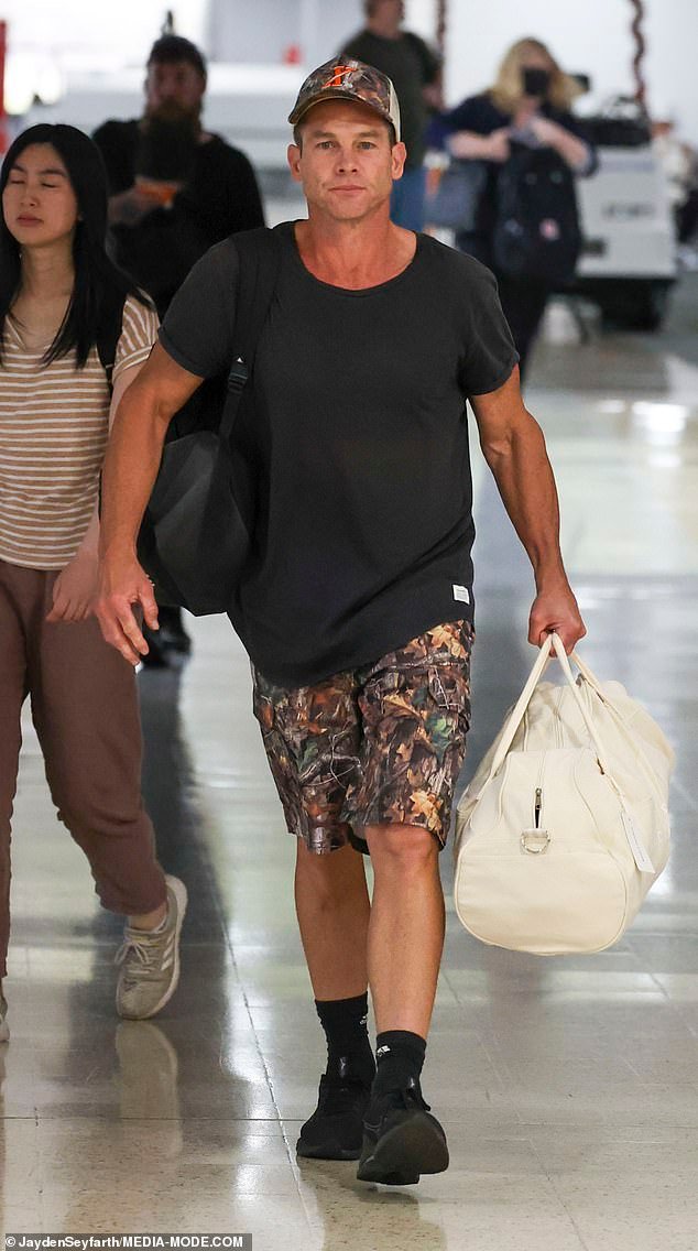 AFL Legend Ben Cousins Poses with Fans, Exhibiting Happiness and Good Health Upon Arrival at Sydney Airport