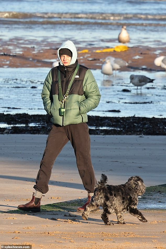 The Crown’s Emma Corrin Takes Their Dog Spencer for a Beach Stroll Following Harry Styles’ Decision to Opt Out of Dog-Sitting Duties After an Unfortunate Evening