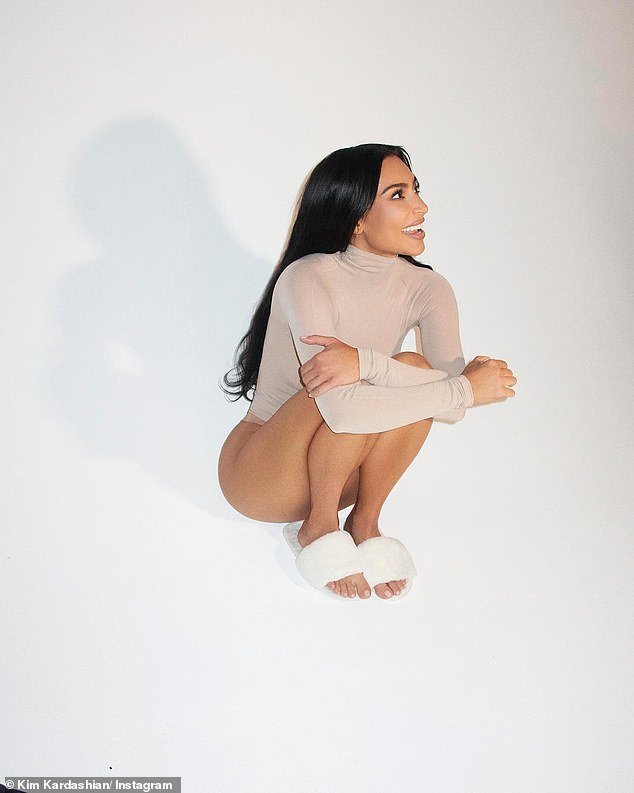 Kim Kardashian promotes SKKN with stunning photos of her radiant complexion and showcased legs in a nude top