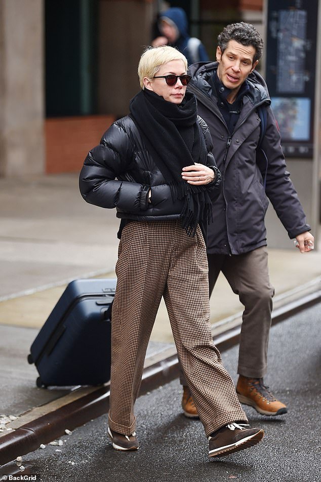 Michelle Williams and husband Thomas Kail keep warm in New York with black puffer jacket and scarf