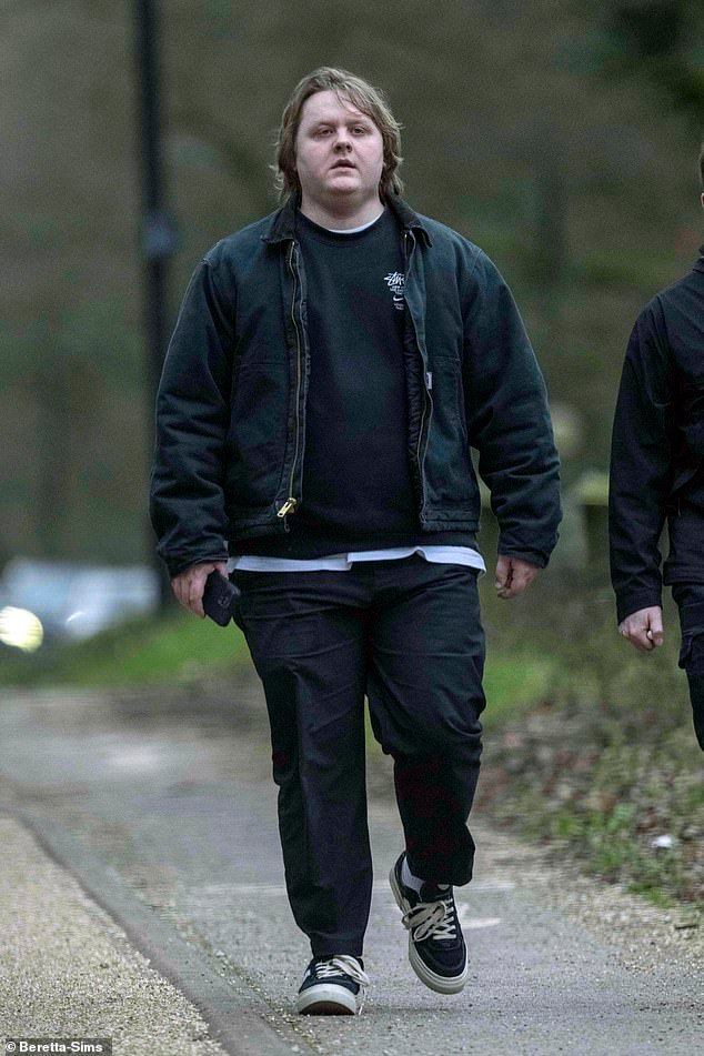 Lewis Capaldi seen in good spirits as he goes for a walk with a friend during his extended career hiatus to prioritize his mental well-being