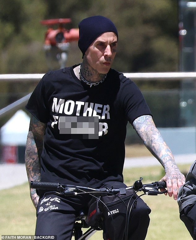 Travis Barker catches attention in Perth with edgy T-shirt and beanie for hot bike ride