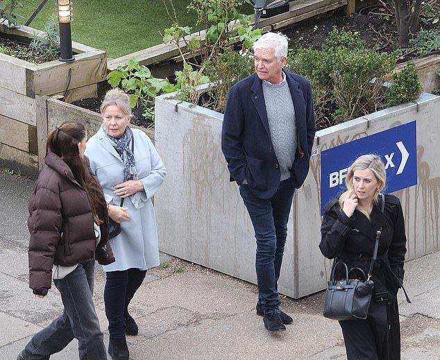 Phillip Schofield and family enjoy a fun day out with friends in London, as they look in high spirits