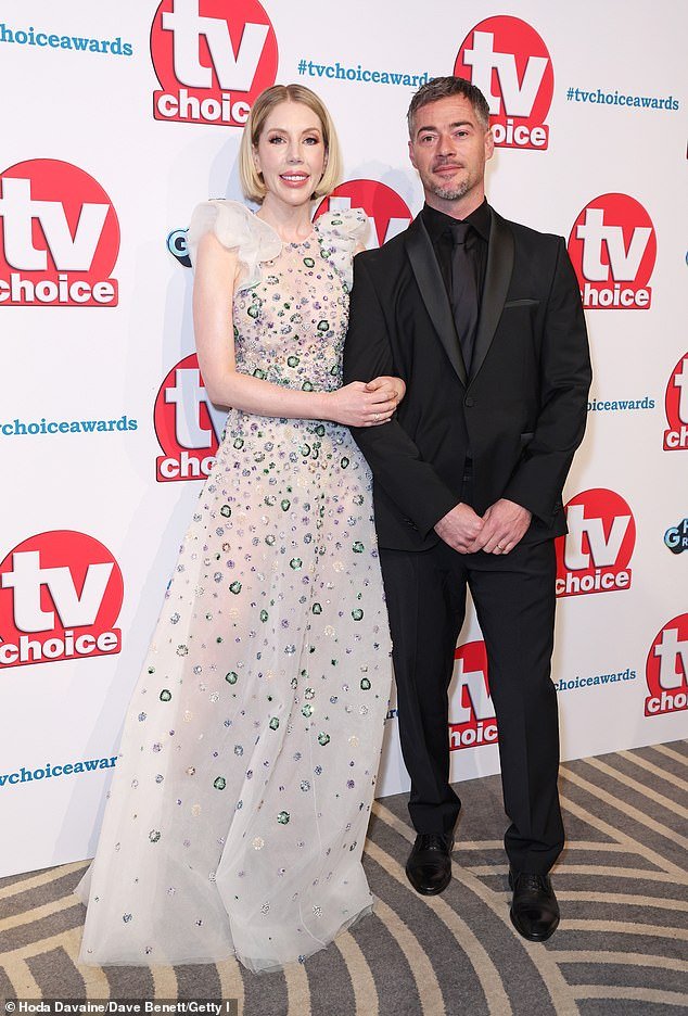 Katherine Ryan Stuns in Semi-Sheer Gown at TV Choice Awards 2024, Posing with Husband Bobby Kootstra in a Glamorous Display