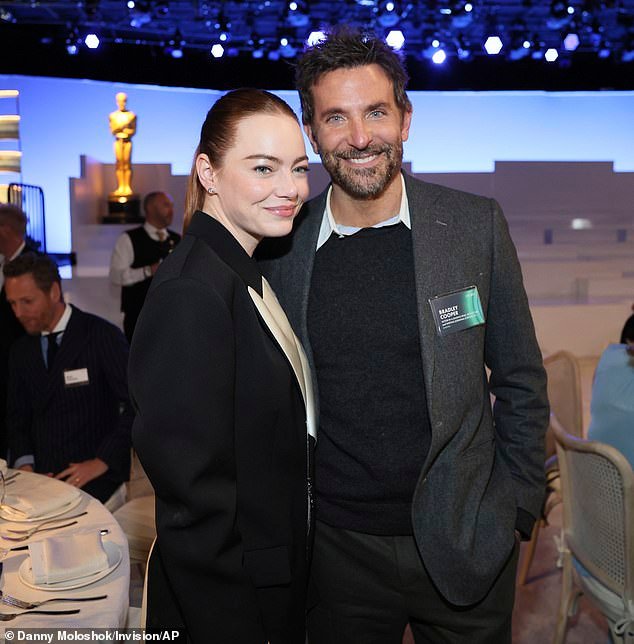 Emma Stone and Bradley Cooper embrace warmly during a reunion at the 96th Academy Awards Nominees Luncheon with an Aloha theme