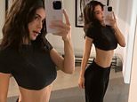 Kylie Jenner flaunts her defined midsection in a cropped top and cozy sweatpants as she strikes a pose in anticipation of Valentine’s Day