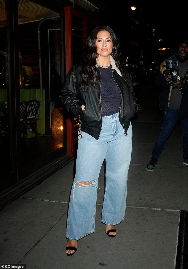 Ashley Graham flaunts her slender physique in a navy mesh top at Gisele Bundchen’s NYFW dinner, following revelations of size discrimination from some designers