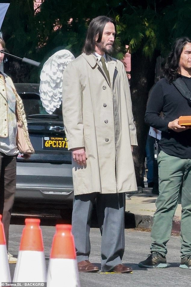 Keanu Reeves dons angel wings as he floats around the set of Aziz Ansari’s latest comedy