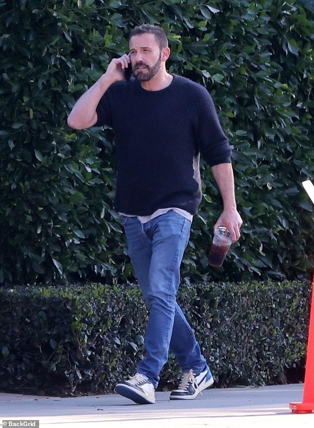 Ben Affleck appears uneasy as he answers a phone call while meeting with ex-wife Jennifer Garner to pick up their son Samuel on Valentine’s Day