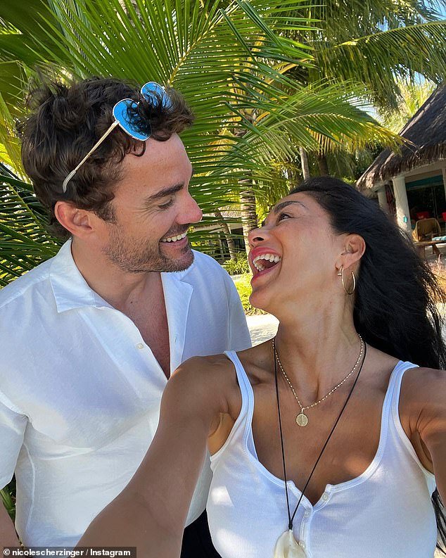 Nicole Scherzinger and fiancé Thom Evans share a romantic Valentine’s Day beach dinner in the Maldives, gazing lovingly at each other.