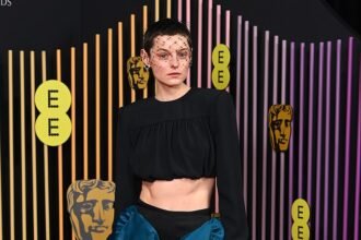 Emma Corrin’s Bold Fashion Choice at the 2024 BAFTAs: Sheer Skirt and Blue Tights Ensemble