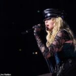 Madonna, 65, falls off a chair on stage in Seattle but quickly recovers with a smile