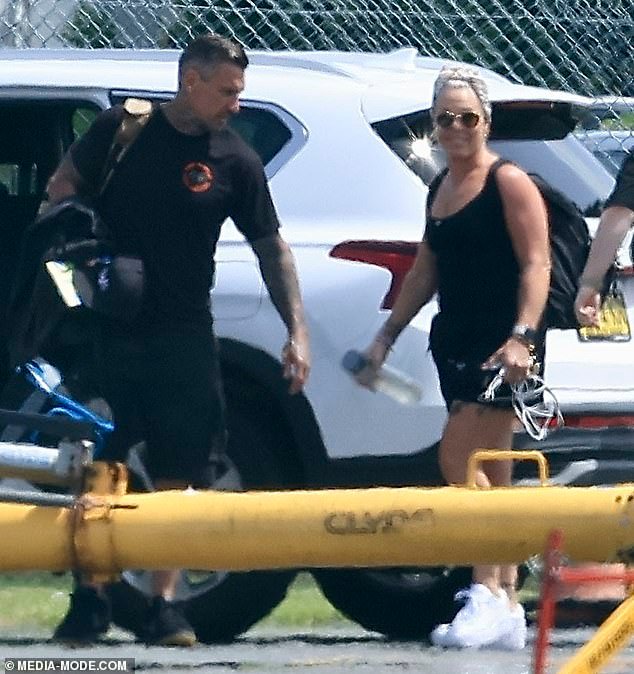 Pink and her husband Carey Hart sport chic all-black outfits as they prepare to fly out of Queensland