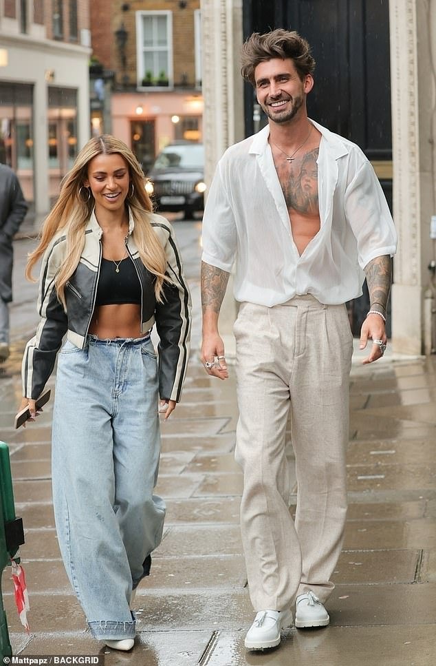 Joanna Chimonides and Chris Taylor show off their toned abs as they make a stylish return to the UK from South Africa on Love Island All Stars