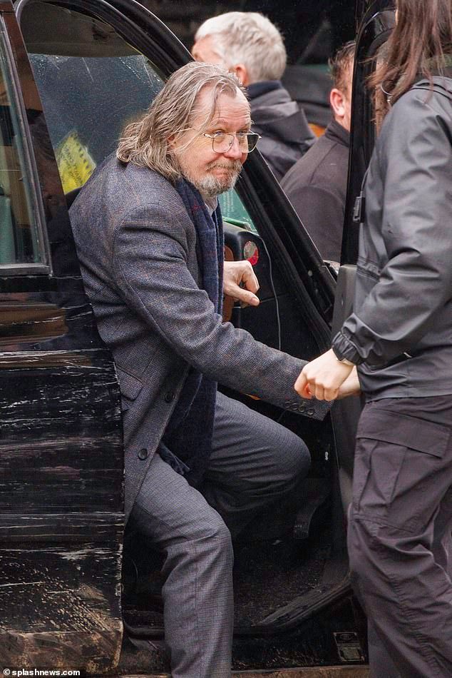 Gary Oldman’s black cab stalls while he films series five in London in the rain