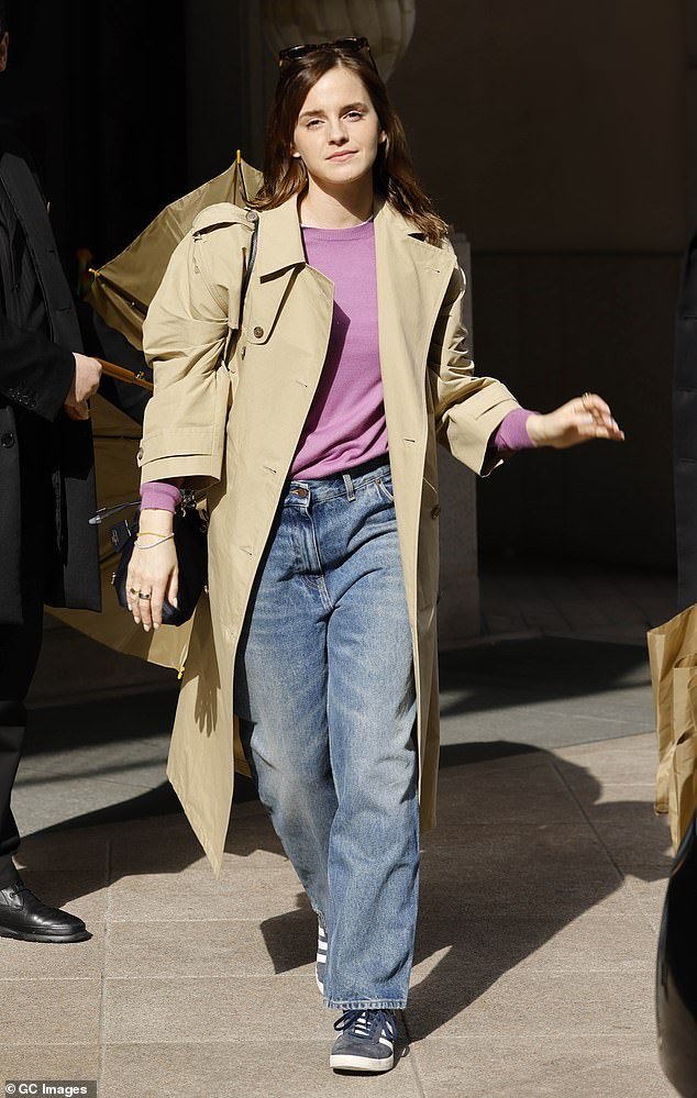 Emma Watson exudes effortless style as she rocks a fashionable trench coat and denim while attending Milan Fashion Week