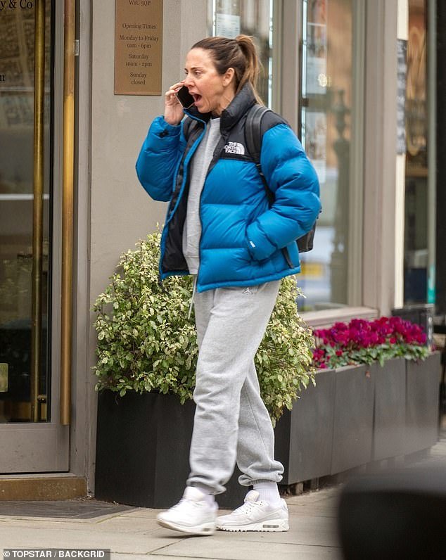 Mel C animatedly chats on the phone while taking a brisk walk in Westminster